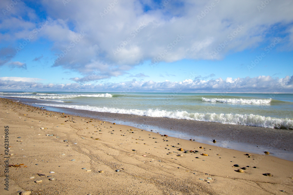 Summer Day Beach Background. Sunny summer day on a wide sandy beach with waves rolling in on a Great Lakes beach. Lakeport State Park, Michigan. Summer Day Beach Background. Sunny summer day on a wide sandy beach with waves rolling in on a Great Lakes beach. Lakeport State Park, Michigan.