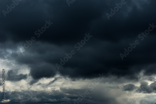 Beautiful grey Fluffy Rain Clouds. Cloudscape after bad weather. Autumn dark Storm Clouds over Black Sky.