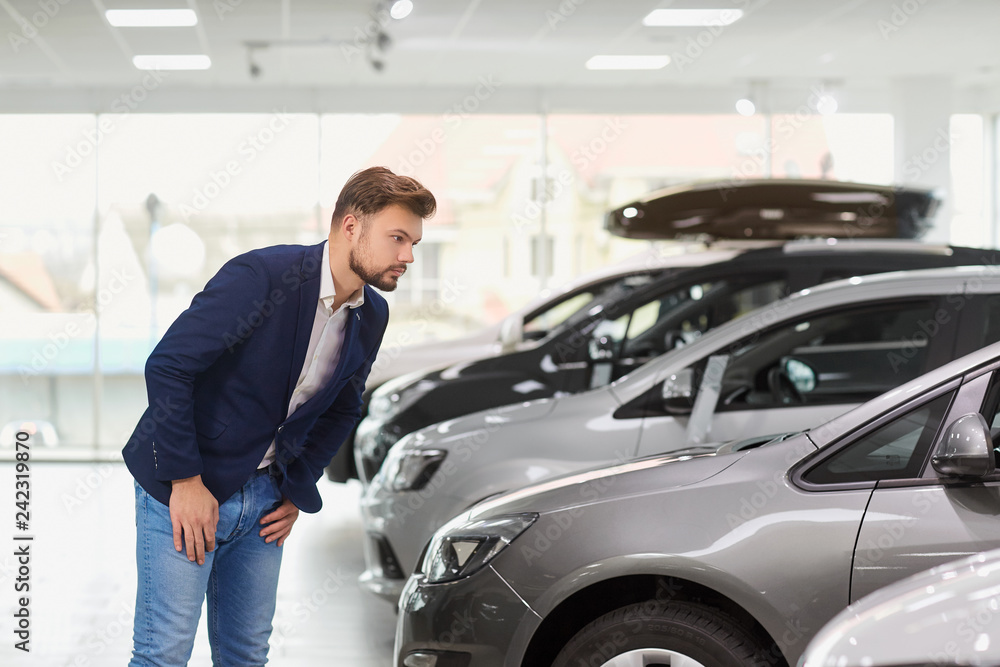 The buyer of the car thinks in the car dealership. The buyer of the car thinks in the car dealership.