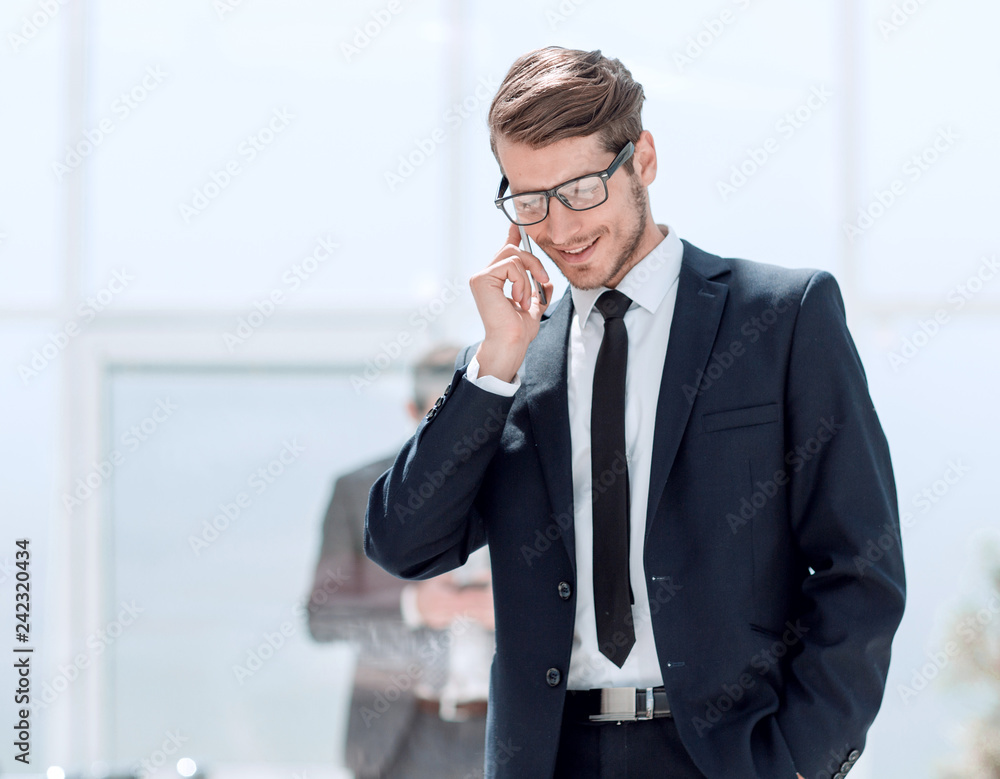 confident businessman talking on a mobile phone. confident businessman talking on a mobile phone.