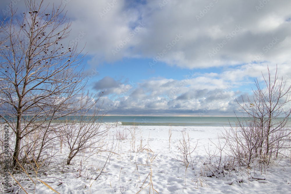 Fototapeta premium Winter Weather Landscape. Sunny winter day on Lake Huron after a lake effect snow storm slams the Great Lakes region in Michigan.