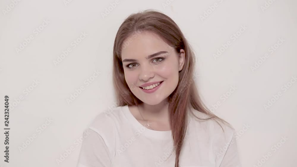 Young woman posing and smiling over white background Young woman posing and smiling over white background