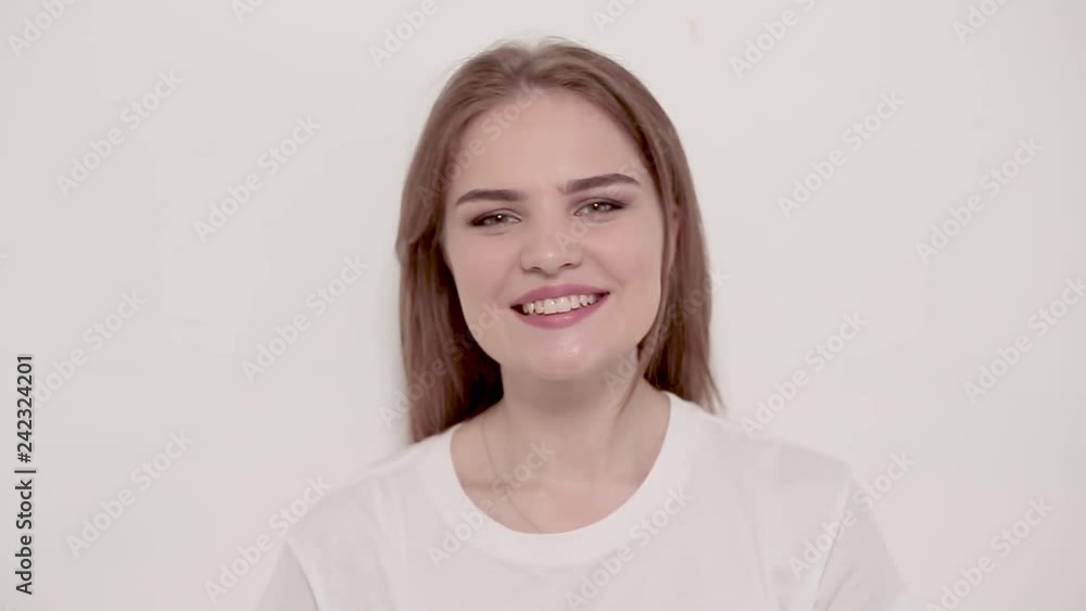 Young woman posing and smiling over white background Young woman posing and smiling over white background