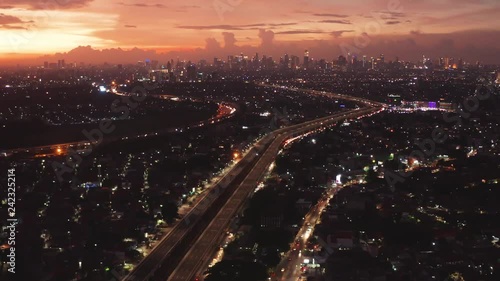 JAKARTA, Indonesia - January 04, 2019: Beautiful aerial view of sunset with landscape of Becakayu toll road and residential houses in Jakarta. Shot in 4k resolution photo