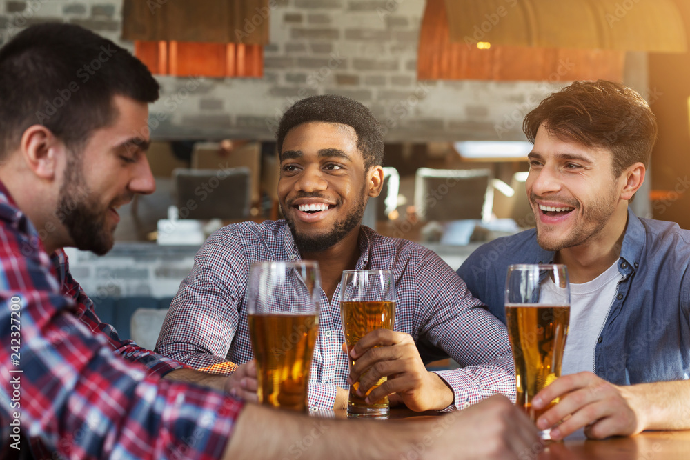 Sharing the latest news. Diverse friends chatting in bar