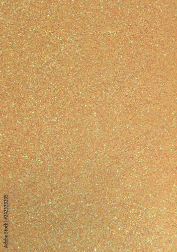 golden background with many glittery shimmering glitter in verti