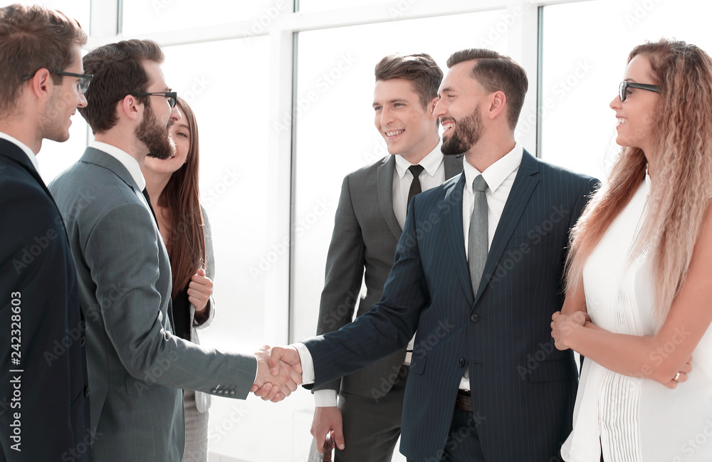 employees greet each other with a handshake employees greet each other with a handshake