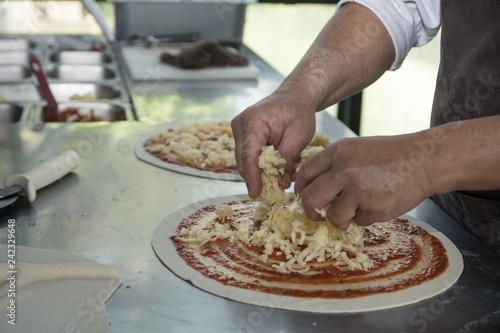 Chef preparing the pizza on the table