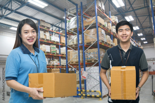 Two workers carrying box in the warehouse (ฺBlur background) , Asian delivery men carrying boxes in the distribution warehouse (ฺBlur background)