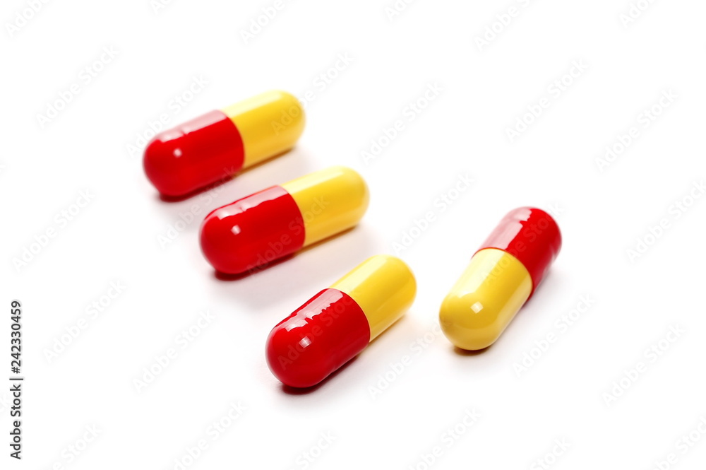 red yellow pills, medicine isolated on white background, top view red yellow pills, medicine isolated on white background, top view