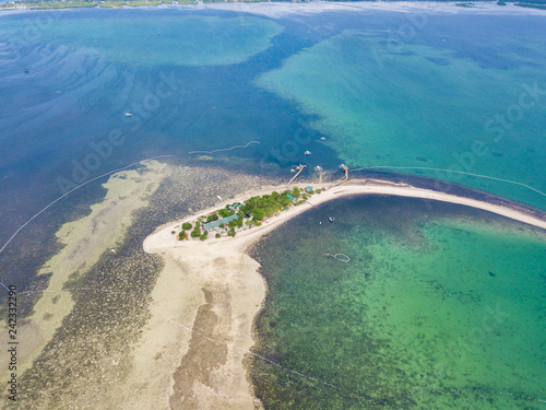 Aerial view of curved beach of Pontod virgin island located near Panglao island, Bohol, Philippines