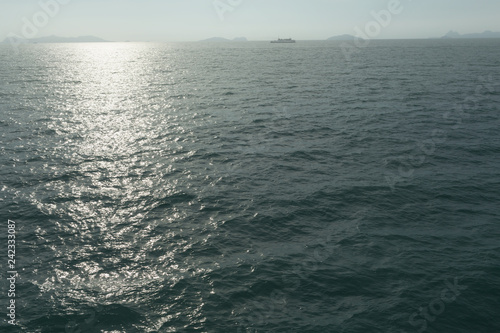 Blue sunny sea water surface with Ferryboat.