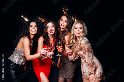 Wall Mural Four young beautiful women together celebrating party