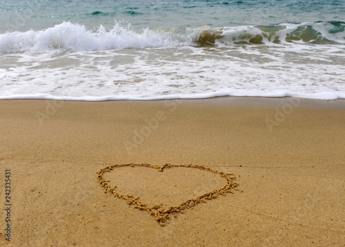 Heart shape handwriting sign on the beach