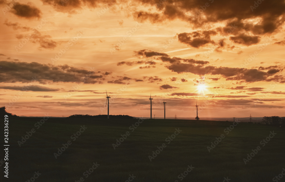Windräder und Feld im Sonnenuntergang