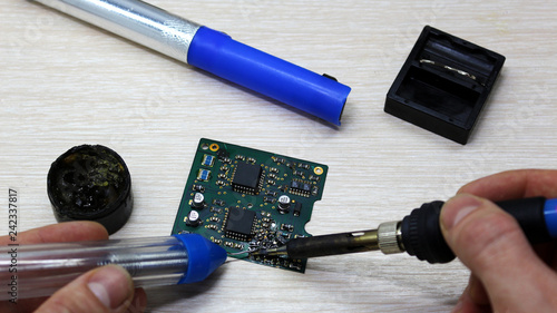 Workshop on repair of household appliances, electronics and processors. soldering Board soldering iron, re-soldering chips, replacing transistors, thyristors, capacitors and varistors. Soldering  photo