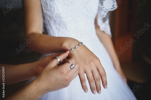 putting a bracelet on brides hand