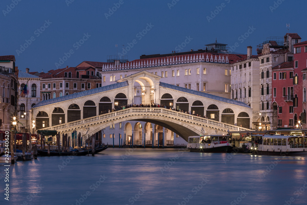 Rialto bridge and Grand Canal at night in Venice, Italy.