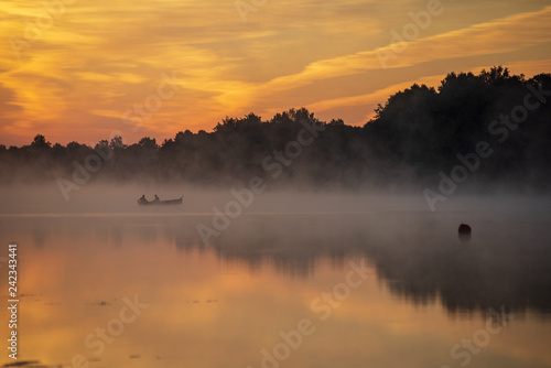 Fototapeta Naklejka Na Ścianę i Meble -  colorful misty sunset on the river in summer