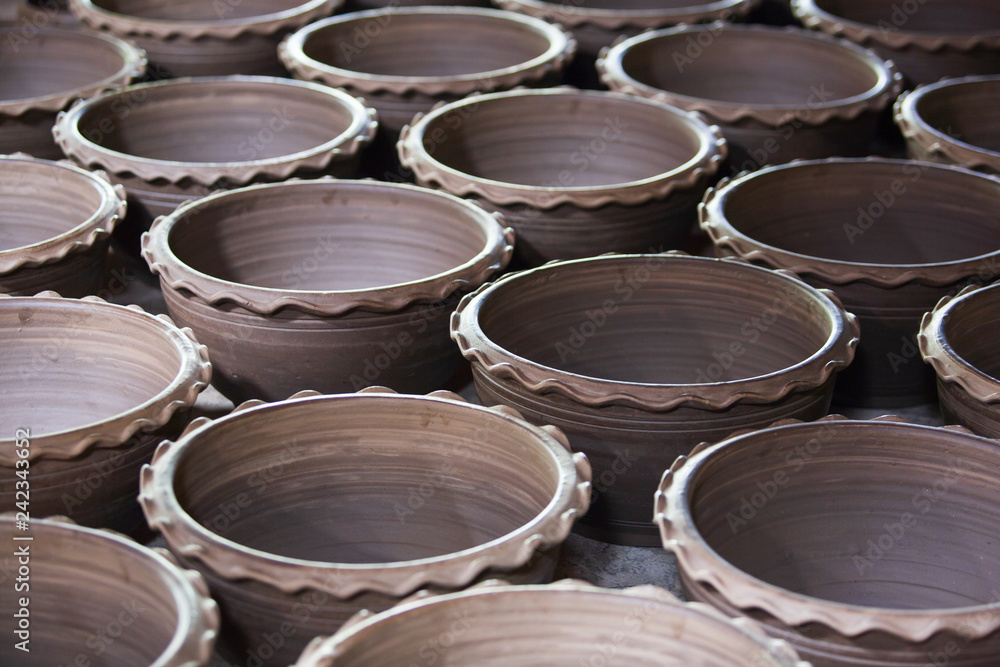 Traditional Thai-Mon pottery in sunlight for natural drying. Traditional Thai-Mon pottery in sunlight for natural drying.