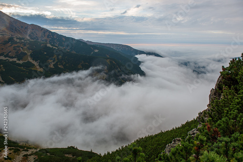large misty cloud climbing mountain valley in slovakia, Tatra © Martins Vanags