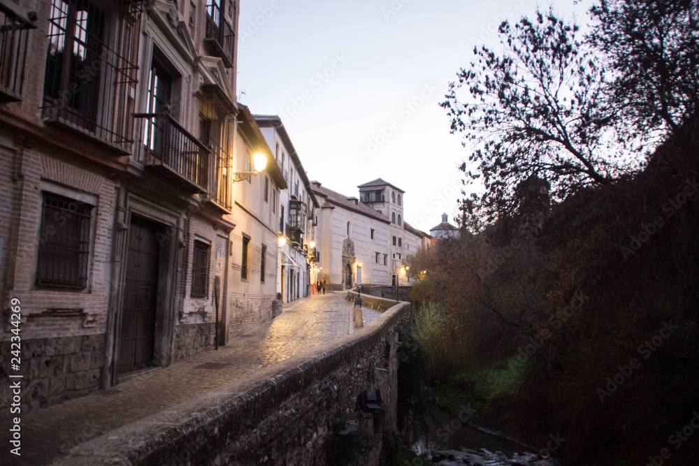 Dawn twilight in Granada, Spain. Carrera del Darro street, Darro river.