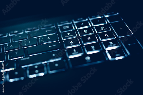 Closeup of laptop keyboard illumination, backlit keyboard