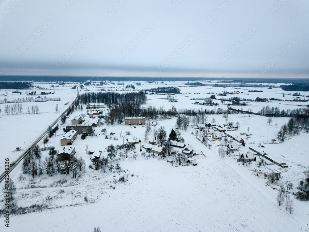 country roads in winter and small village from above country roads in winter and small village from above