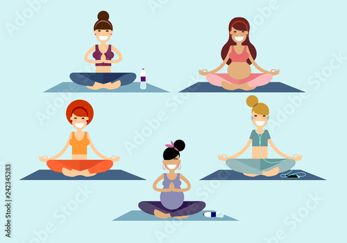 A group of yoga girls and young ladies meditates sitting on a pilates mat in a Sukhasana easy pose