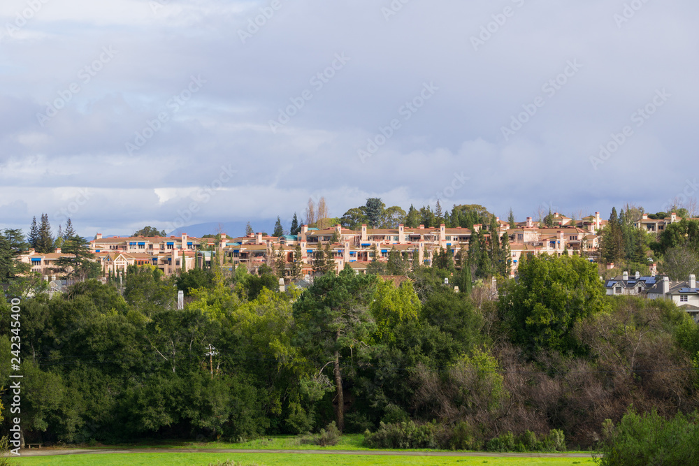 Residential buildings at the edge of a park on a stormy day, south San Francisco bay area, California