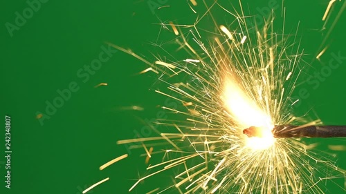 Burning bengal light in real time. Fire sparkler moving on green screen background. 4K video footage