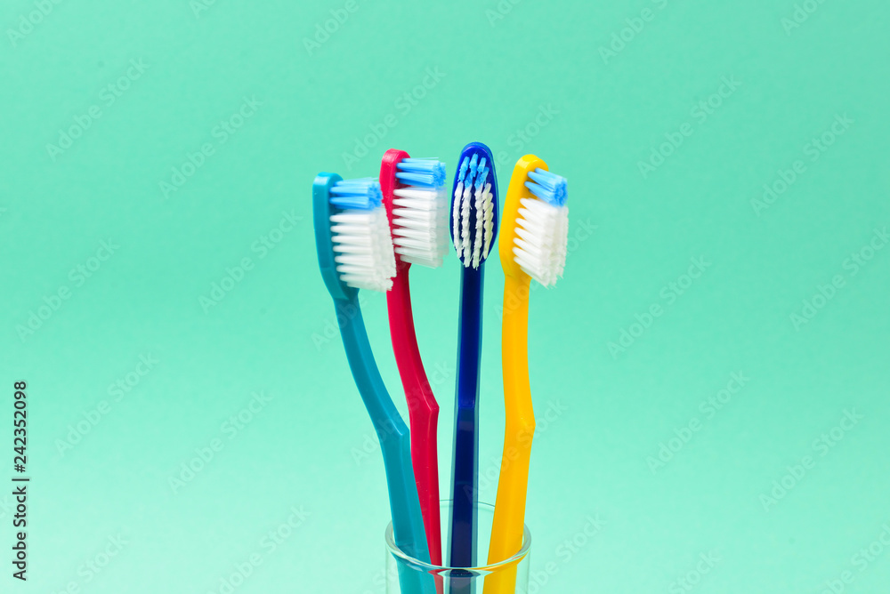 Toothbrushes on a green background. Space for text or design. Toothbrushes on a green background. Space for text or design.
