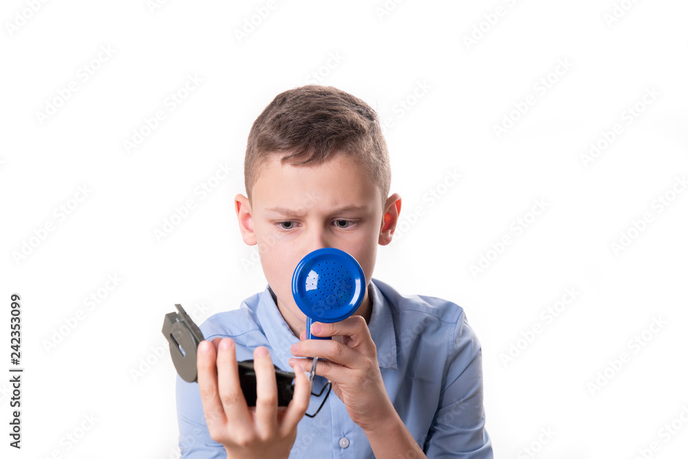Fototapeta premium Boy explains the way with a blue megaphone and a compass in hand against a white background
