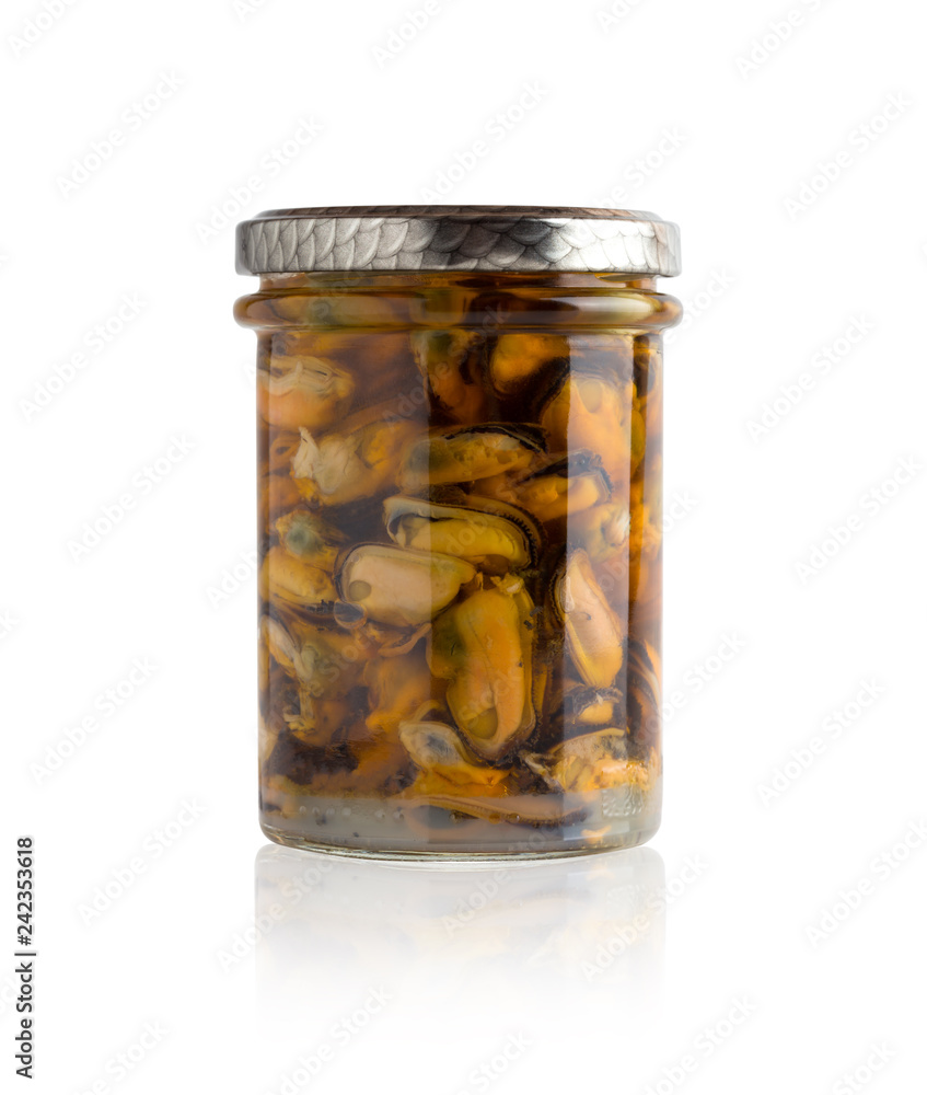 Marinated mussels in a glass jar. Mussels without leaf marinated in a jar on a white background. Marinated mussels in a glass jar. Mussels without leaf marinated in a jar on a white background.