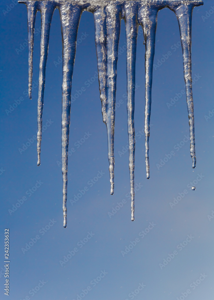 Winter icicles on a background of the early sun frosty morning Winter icicles on a background of the early sun frosty morning