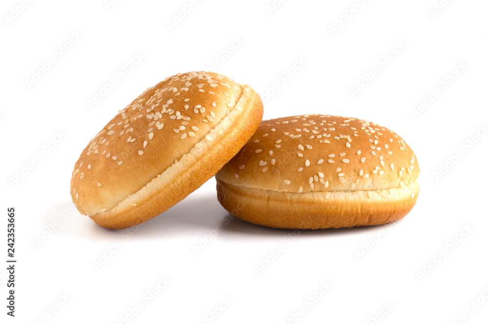 Burger buns on white background. Two buns cut in half close up on a white background. Burger buns on white background. Two buns cut in half close up on a white background.