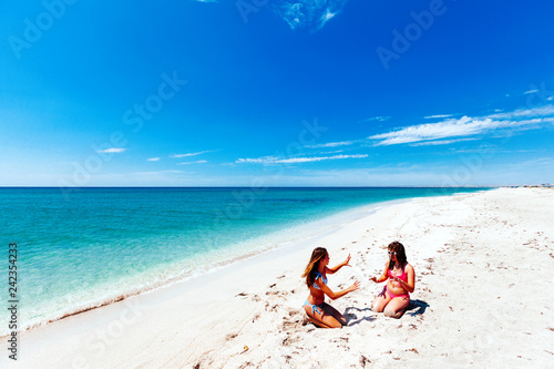 Teenage friends playing on the beach