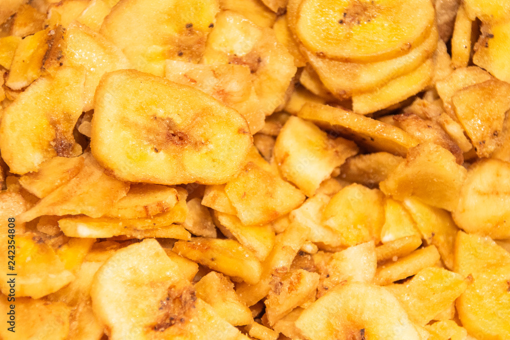 Banana chips, slices of fresh ripe bananas as food background Banana chips, slices of fresh ripe bananas as food background