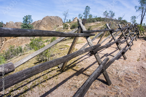 Wooden barrier on the side of a hiking trail, Pinnacles National Park, California