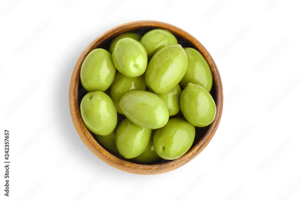 Delicious big green olives in a wooden bowl, isolated on white background, view from above Delicious big green olives in a wooden bowl, isolated on white background, view from above
