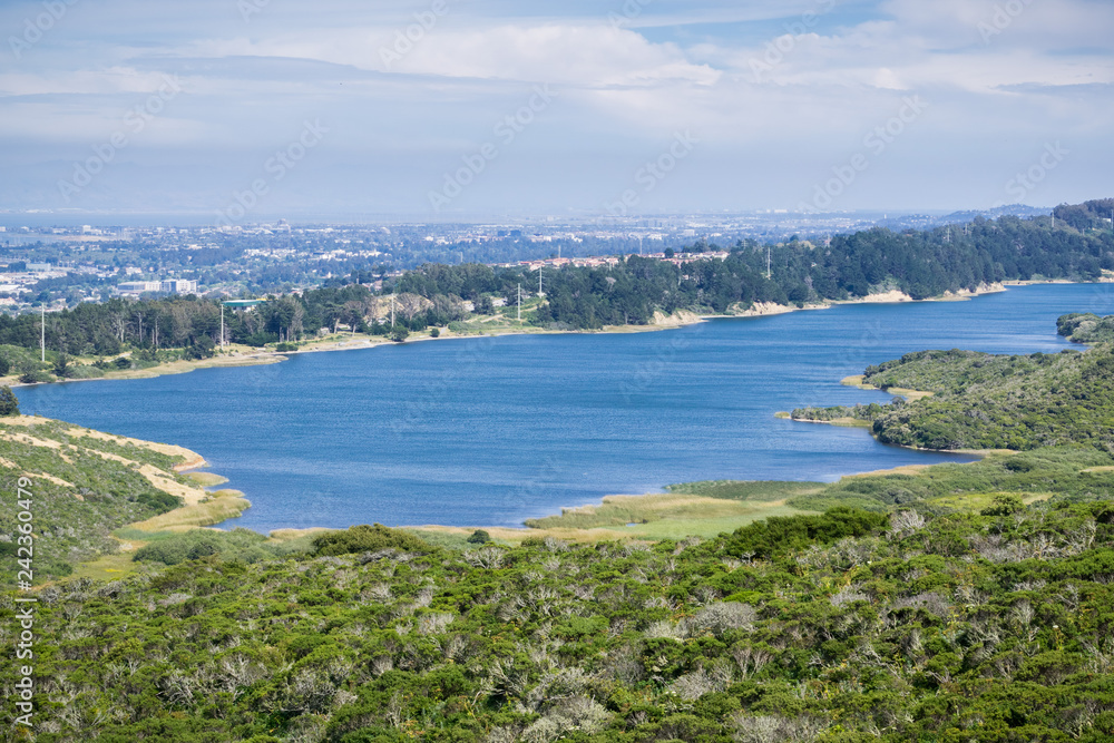 San Andreas reservoir landscape; the towns of San Francisco bay in the background, California San Andreas reservoir landscape; the towns of San Francisco bay in the background, California