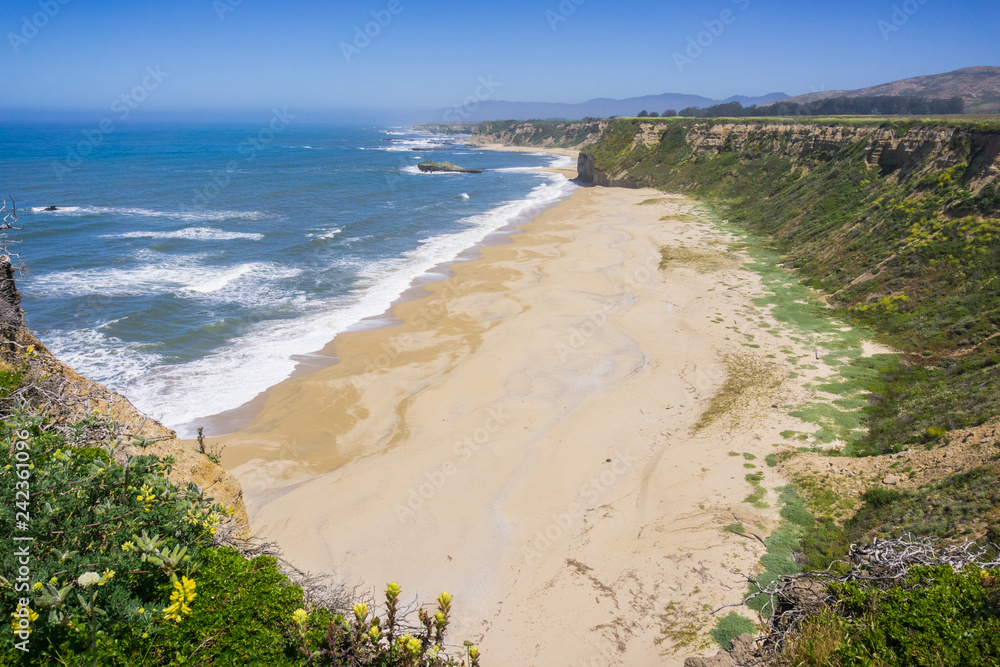 Cliffs and sandy beach on the Pacific Ocean coastline near Half Moon Bay, California