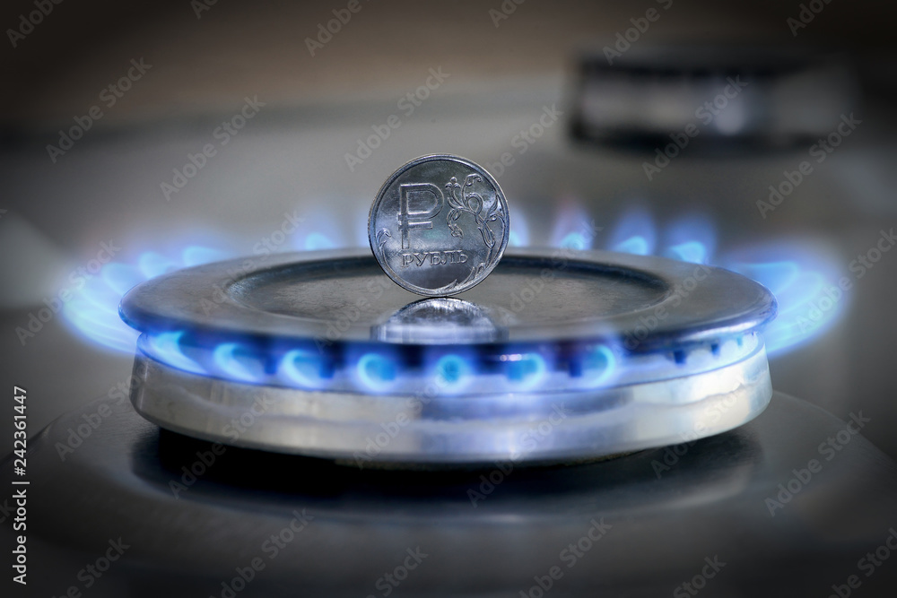 Gas hob with burning natural gas and Russian rouble coin Gas hob with burning natural gas and Russian rouble coin