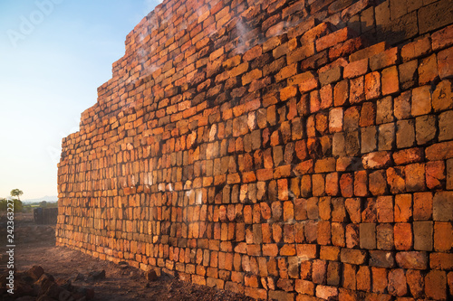 The smoke from an active brick kiln, where thousands of bricks stacked together on a greater height.