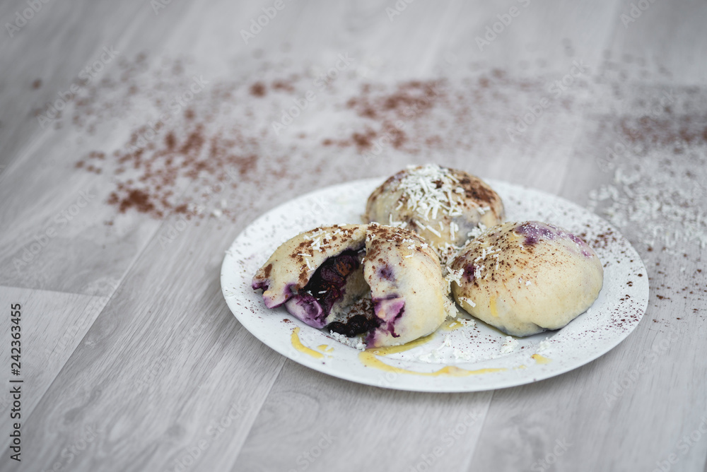 Czech or European typical meal, sweet stuffed dumplings, often with plum, strawberry or another fruit, served with chocolate, cocoa, butter and curd, eaten as a dessert after dish, liked by children Czech or European typical meal, sweet stuffed dumplings, often with plum, strawberry or another fruit, served with chocolate, cocoa, butter and curd, eaten as a dessert after dish, liked by children