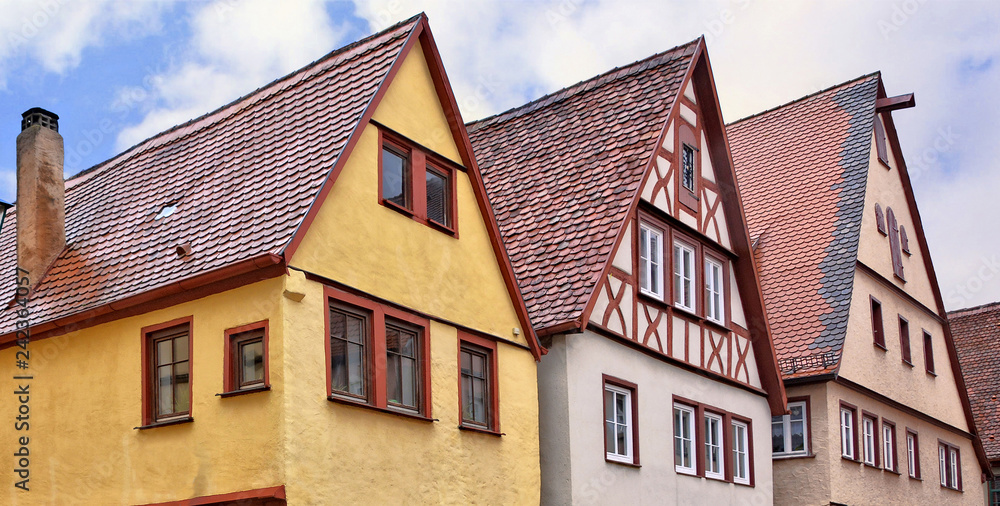 Traditional German architecture. Top of ancient half-timbered housse in a medieval old town. Germany. Bavaria. Rothenburg ob der Tauber. Traditional German architecture. Top of ancient half-timbered housse in a medieval old town. Germany. Bavaria. Rothenburg ob der Tauber.