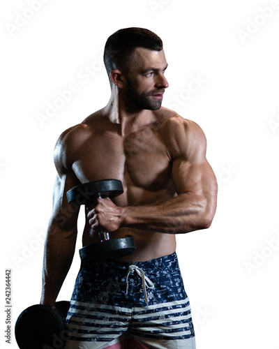 isolated handsome young muscular man exercising with dumbbells. Guy trains his bicep