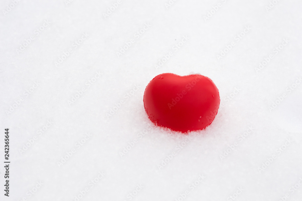 Fototapeta premium White red heart in snow. Valentine's day and love concept. Copy space for text.