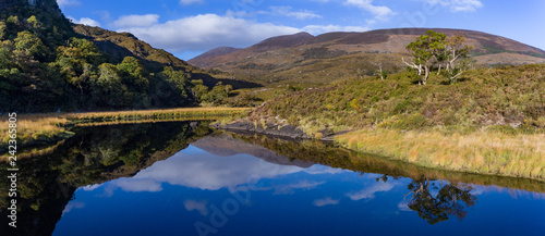 Scenic lakes of Killarney national park, landscape reflected in still water, Ring of Kerry, Ireland. 