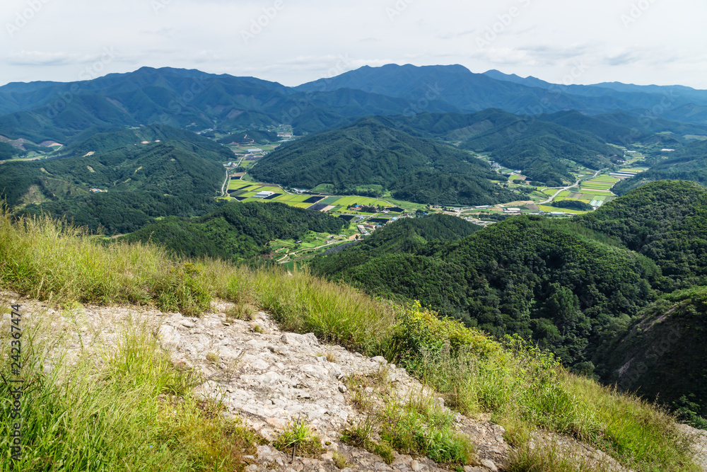 View into the valley with fields and hills from the top of Maisan mountain, horse ear mountain, Maryeong-myeon, South Korea